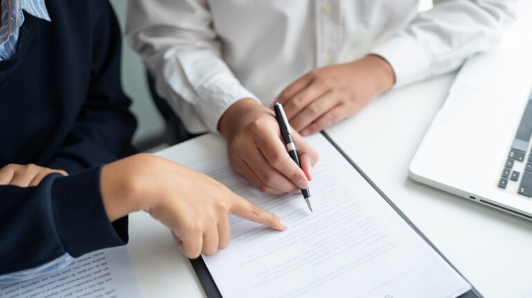 lawyer is showing where to sign