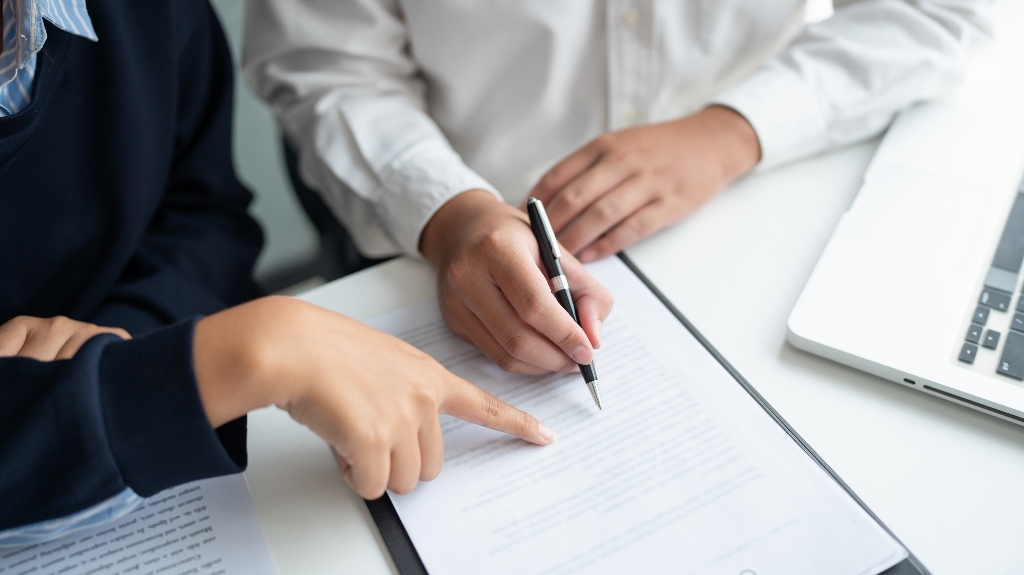 lawyer is showing where to sign