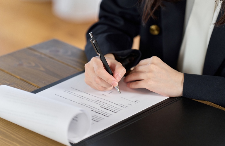 woman is signing the document