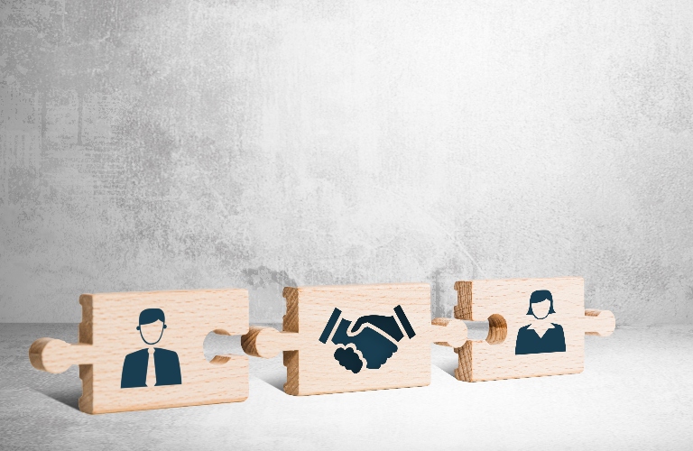 Wooden puzzle with icons of a man, mediator and woman
