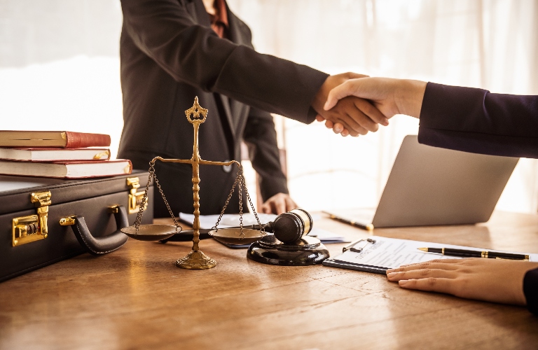 lawyer shakes hands with a client