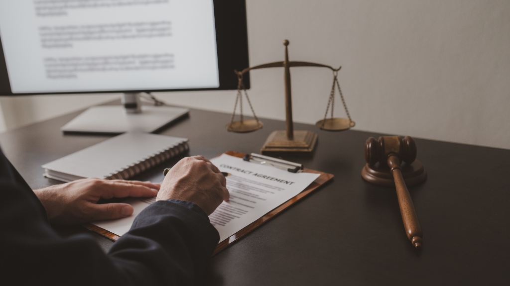 Lawyer sits in office with documents