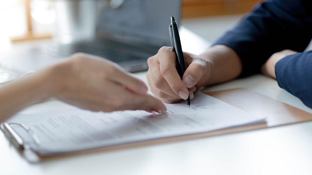 Woman is signing documents
